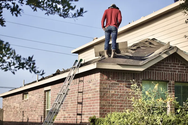 Professional roofer working on a residential roof in Barrington